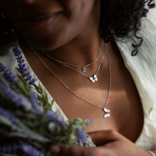 A woman wearing butterfly jewellery.