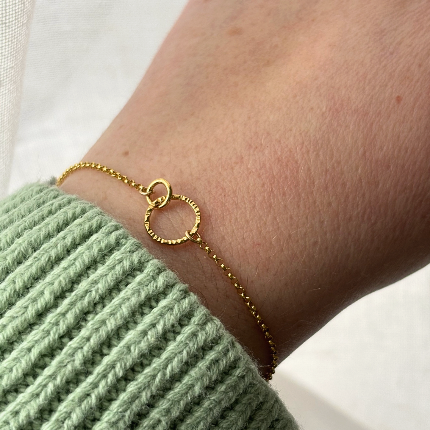 gold chain bracelet on a wrist
