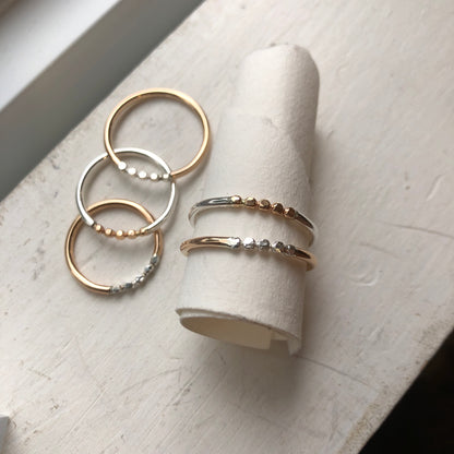 Mixed metal rings on a paper scroll.