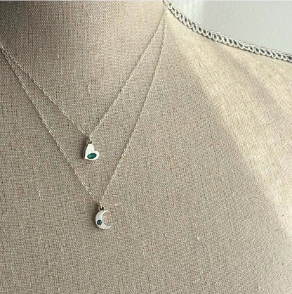 Necklace with pendant on a mannequin bust against a neutral background