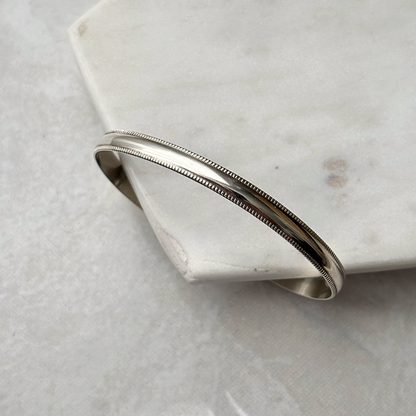 Silver bracelet on a marble surface