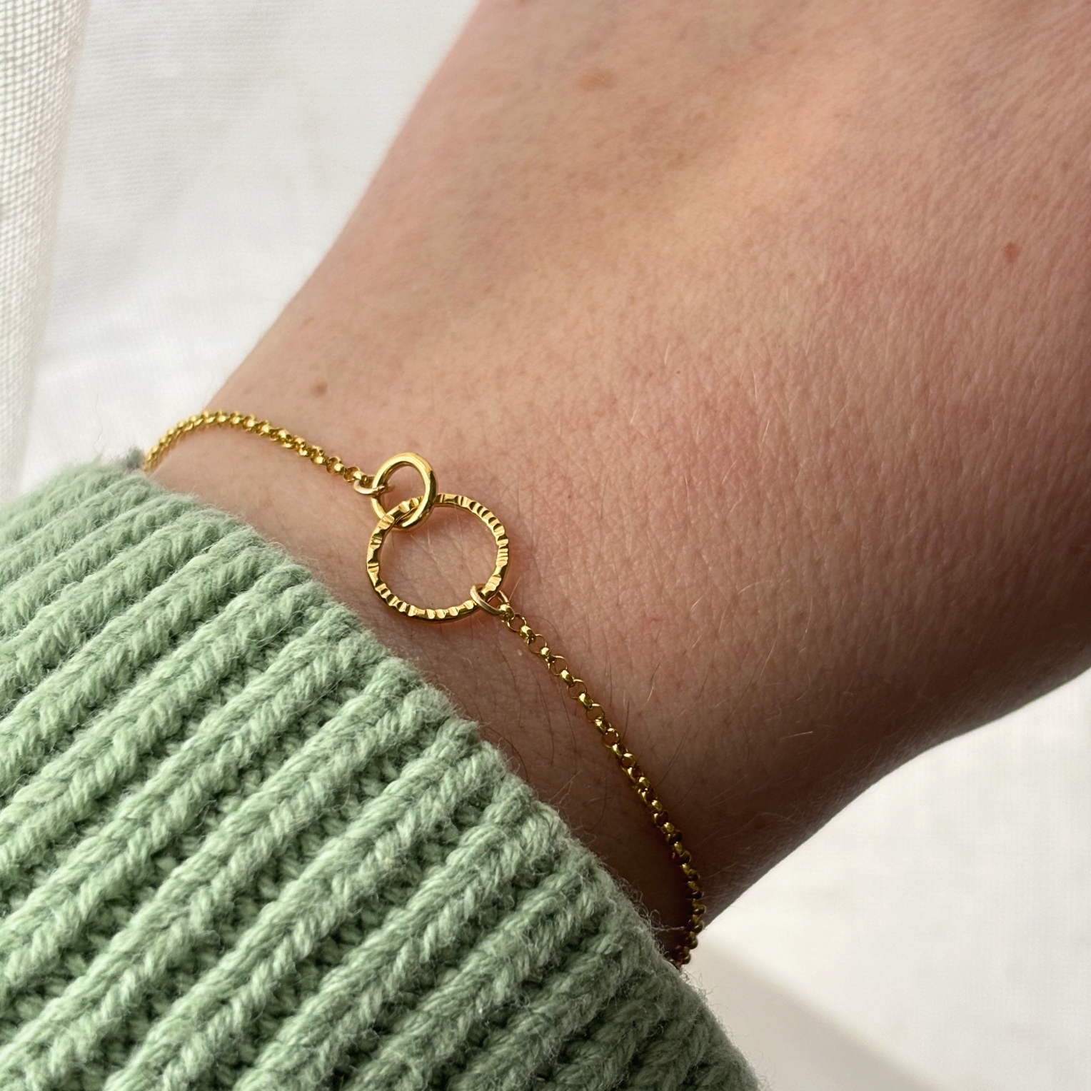 gold chain bracelet on a wrist