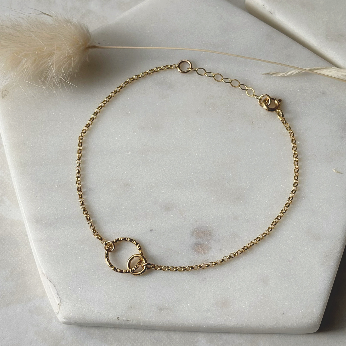gold chain bracelet on a marble background